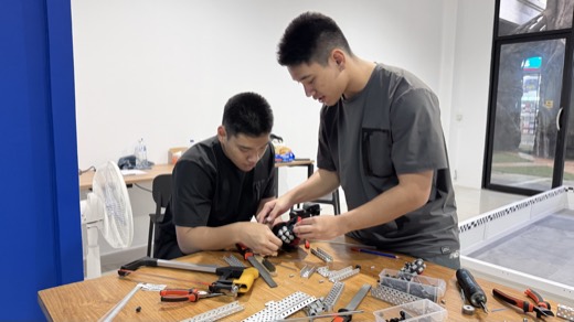 Students working with a VEX V5 robot at NEXTRA